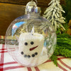 Two sizes of a snowman LED Candle in a clear plastic ornament. Available at Quilted Cabin Home Decor.