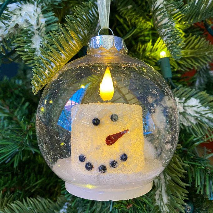 Two sizes of a snowman LED Candle in a clear plastic ornament. Available at Quilted Cabin Home Decor.