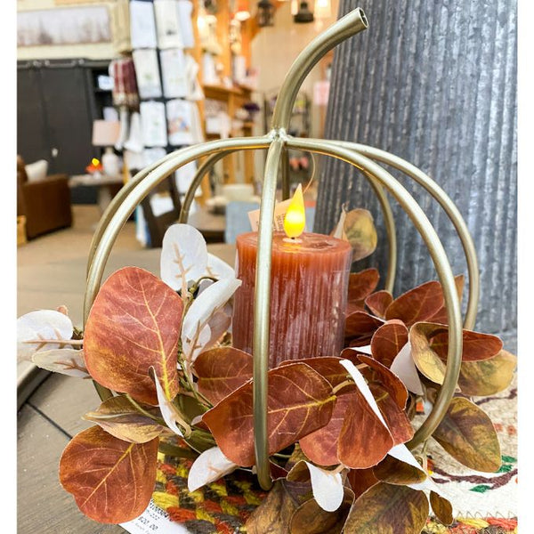 Gold Pumpkin lantern candle holder with leaves and a lit orange votive candle. Orange Ridged LED 4" Votive Candle available at Quilted Cabin Home Decor.