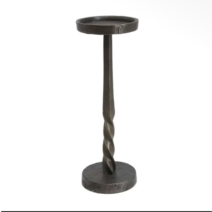 A rustic black metal candle holder with a twisted stem, featuring a circular top cup and a round base, shown against a plain white background.  Two sizes of candle holders available at Quilted Cabin in Airdrie