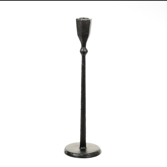 A single black metal candlestick holder with a long stem, a flared top cup, and a round base, shown against a plain white background.  Candle holder comes in two sizes available at Quilted Cabin in Airdrie
