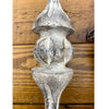 Decorative wood finial on a wooden background. Vintage Wood Finial Ornament available at Quilted Cabin Home Decor.