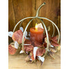Decorative pumpkin-shaped candle holder with a lit candle and autumn leaves. Gold Pumpkin Lantern available at Quilted Cabin Home Decor.