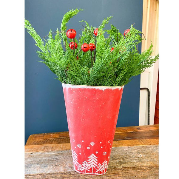 Red & White Tree Wall Bucket is a tall red metal bucket with white christmas trees and snowflakes along the bottom of it. Available at Quilted Cabin Home Decor.