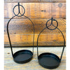 Two black metal hanging planters on a wooden background.  Black Metal Open Lanterns - Set of Two available at Quilted Cabin Home Decor.