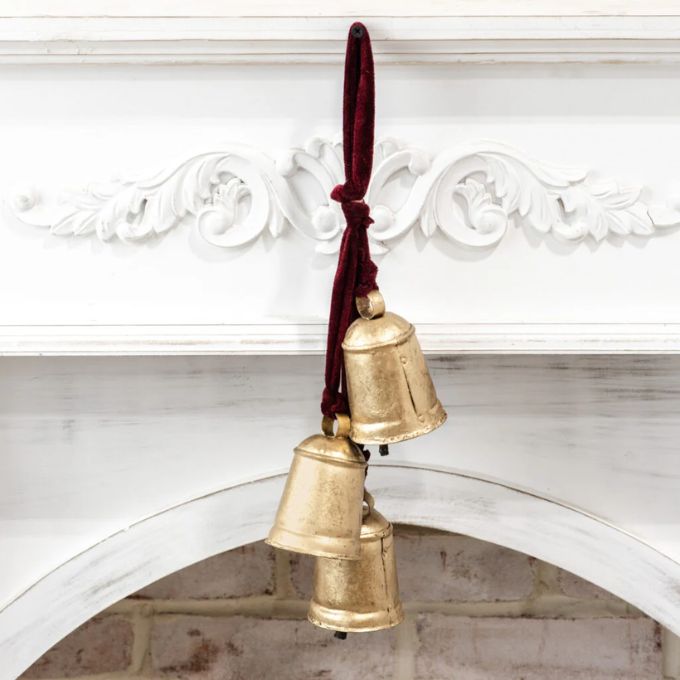 Three gold cow bells hang from a red velvet rope and makes a lovely decoration. Available at Quilted Cabin Home Decor.