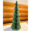Green paper Christmas tree against a wooden wall. Vintage Green Paper Trees - Two Sizes available at Quilted Cabin Home Decor.