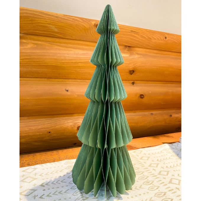 Green paper Christmas tree against a wooden wall. Vintage Green Paper Trees - Two Sizes available at Quilted Cabin Home Decor.
