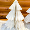 White paper Christmas trees on a wooden surface. Vintage White Paper Trees - Three Sizes available at Quilted Cabin Home Decor.