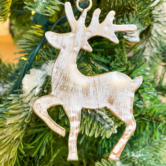 White washed gold deer ornaments in two styles - one is standing and one is flying. Available at Quilted Cabin Home Decor.