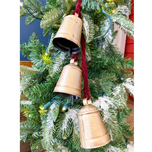 Three gold cow bells hang from a red velvet rope and makes a lovely decoration. Available at Quilted Cabin Home Decor.