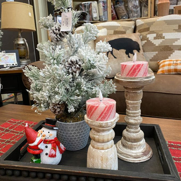 Decorative items including candles, a small tree, and a snowman figurine on a table. Short Peppermint Votive LED Timer Candles - Set of Two available at Quilted Cabin Home Decor.