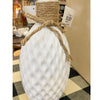 Decorative white bottle with textured surface and jute bow on a checkered table runner. Porcelain Textured Vase available at Quilted Cabin Home Decor.