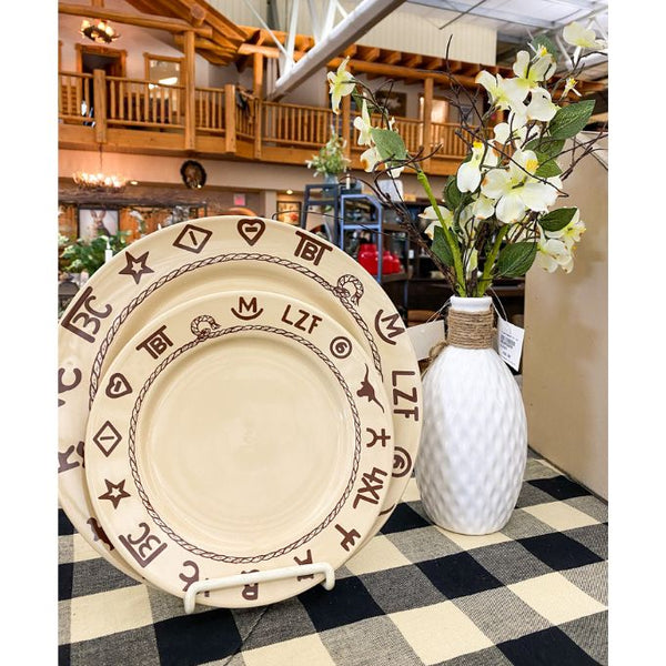 Decorative plates with patterns next to a white vase with flowers on a checkered table runner. Porcelain Textured Vase available at Quilted Cabin Home Decor.
