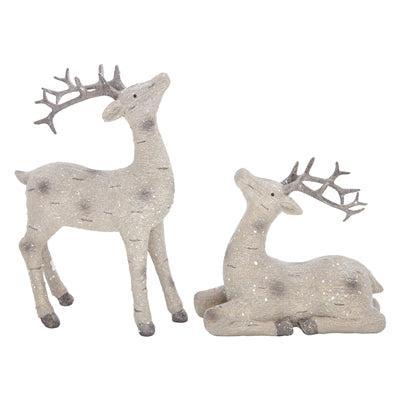 Two decorative deer figurines in a light beige glitter finish, one standing and one reclining, both with gray antlers available at Quilted Cabin in Airdrie
