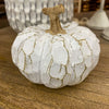 Decorative pumpkin with white texture on a wooden surface, one of the White Carved Pumpkins - Two Styles available at Quilted Cabin Home Decor.