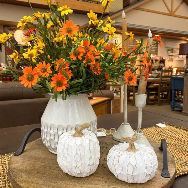 Decorative table setting with flowers, pumpkins, and candles in a cozy indoor setting.  White Carved Pumpkins - Two Styles available at Quilted Cabin Home Decor.