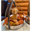 A tan fox figurine with a white chest and white tipped tail sits surrounded by a autumn colored candle ring. Available at Quilted Cabin Home Decor.