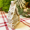 Two small gingerbread houses with lots of snow on the roof available at Quilted Cabin Home DEcor.