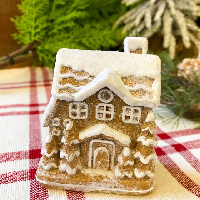 Two small gingerbread houses with lots of snow on the roof available at Quilted Cabin Home DEcor.