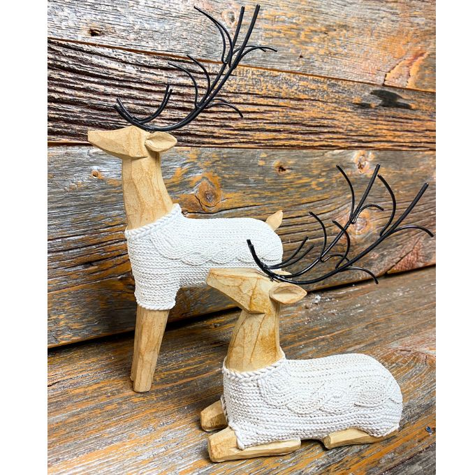 Two resin deer figurines with white cable knit sweaters are shown, one is sitting and one standing. Available at Quilted Cabin Home Decor.