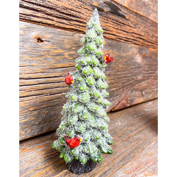 A green frosty evergreen tree figurine with red cardinals on it available at Quilted Cabin Home Decor.