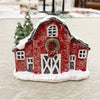Small red barn figurine with snow on a light background. Snowy Red Barn Figurine available at Quilted Cabin Home Decor.