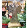 Decorative angel figurine with ribbed texture on a stand, surrounded by greenery and red ornaments. Midnight Shimmer Angels - Two Sizes available at Quilted Cabin Home Decor.