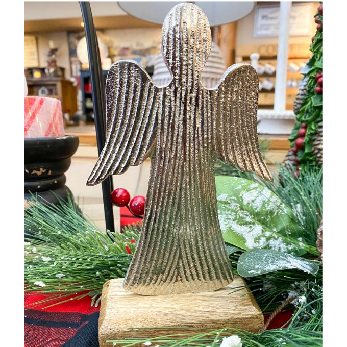 Decorative angel figurine with ribbed texture on a stand, surrounded by greenery and red ornaments. Midnight Shimmer Angels - Two Sizes available at Quilted Cabin Home Decor.