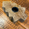 Wooden tree shaped taper holder on a wooden surface. Wooden Tree Taper Holder available at Quilted Cabin Home Decor.