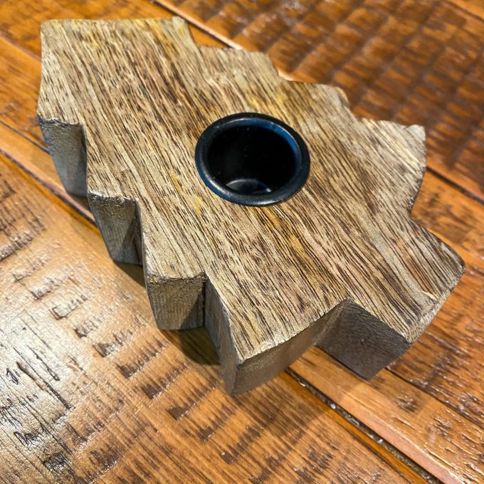 Wooden tree shaped taper holder on a wooden surface. Wooden Tree Taper Holder available at Quilted Cabin Home Decor.
