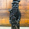 Decorative metal vintage santa claus figure on a wooden background. Tarnished Santa Figurine available at Quilted Cabin Home Decor.