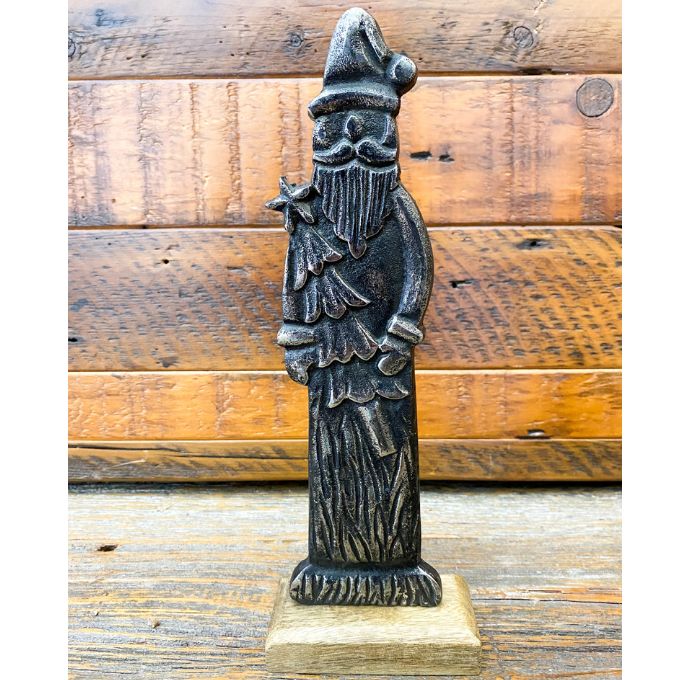 Decorative vintage santa figure with a beard and hat on a wooden background. Tarnished Santa Figurine available at Quilted Cabin Home Decor.
