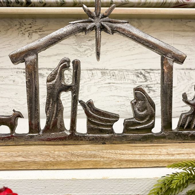 Decorative nativity scene on a wooden shelf with a rustic background. Nativity Silhouette available at Quilted Cabin Home Decor.