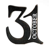 A rustic black wooden number 31 with the word 'OCTOBER' in white lettering, shown on a plain white background. Available at Quilted Cabin in Airdrie