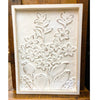 Decorative wall art with floral patterns on a wooden surface. Embossed Whitewashed Flower Frame available at Quilted Cabin Home Decor.