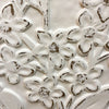 Close-up of floral embossed pattern on a textured surface. Embossed Whitewashed Flower Frame available at Quilted Cabin Home Decor.