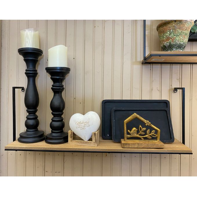 Decorative shelf with black candle holders, white heart-shaped sign, and decorative metal piece against a wooden paneled wall. Bird and Branch Hut Stands - Two Sizes available at Quilted Cabin Home Decor.
