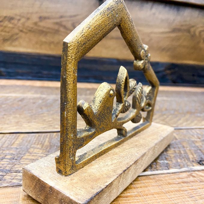 Bronze bird sculpture on a wooden surface. Bird and Branch Hut Stands - Two Sizes available at Quilted Cabin Home Decor.