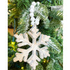 White distressed wooden snowflake ornaments in two different styles on white beaded hangers available at Quilted Cabin Home Decor.