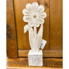 Decorative white flower sculpture on a wooden base with a wooden panel background. Whitewashed Wooden Flowers - Three Styles available at Quilted Cabin Home Decor.
