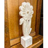 Carved wooden flower sculpture on a wooden surface. Whitewashed Wooden Flowers - Three Styles available at Quilted Cabin Home Decor.