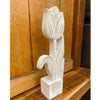 Carved wooden tulip sculpture on a wooden surface. Whitewashed Wooden Flowers - Three Styles available at Quilted Cabin Home Decor.
