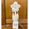 White wooden flower sculpture on a wooden surface. Whitewashed Wooden Flowers - Three Styles available at Quilted Cabin Home Decor.