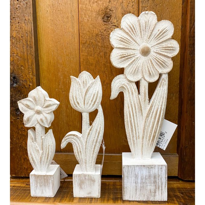 Set of three decorative wooden flower sculptures against a wooden background. Whitewashed Wooden Flowers - Three Styles available at Quilted Cabin Home Decor.