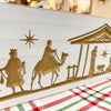 Wooden nativity scene cutout with three wise men on a white background. Distressed White Carved Nativity Block Sign available at Quilted Cabin Home Decor.