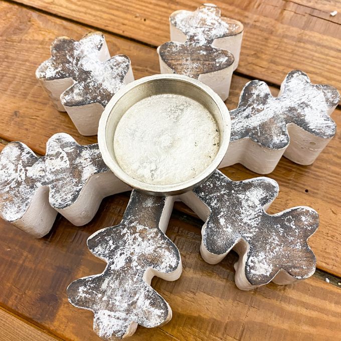 Decorative candle holder with snowflake designs on a wooden surface. Vintage Snowflake Tea Light Holder available at Quilted Cabin Home Decor.