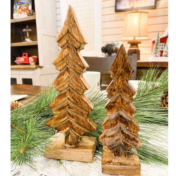 Wooden Christmas tree decorations on a table with greenery. Dark Mango Trees - Set of Two available at Quilted Cabin Home Decor.
