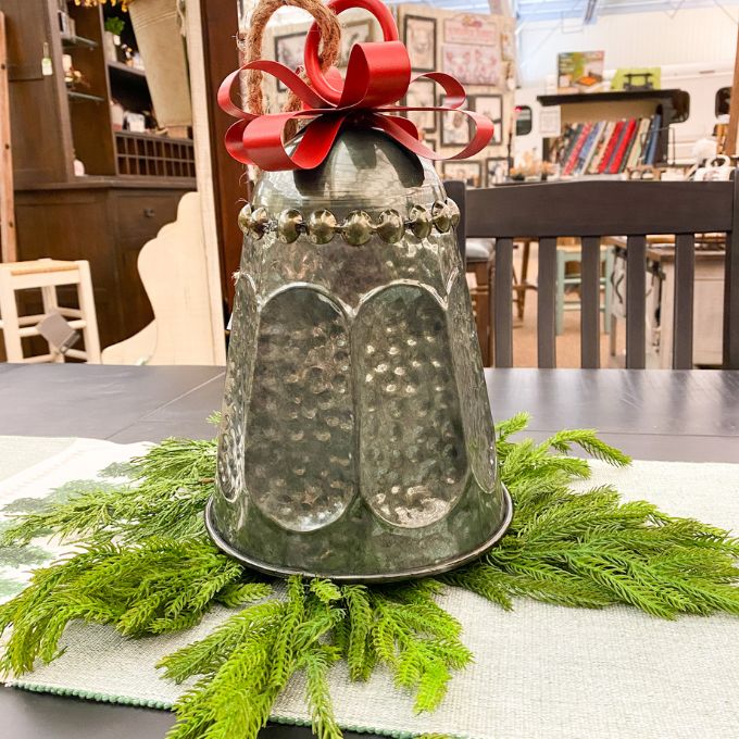 Dark Galvanized Sculpted Bell with Bow Hanger available at Quilted Cabin Home Decor.