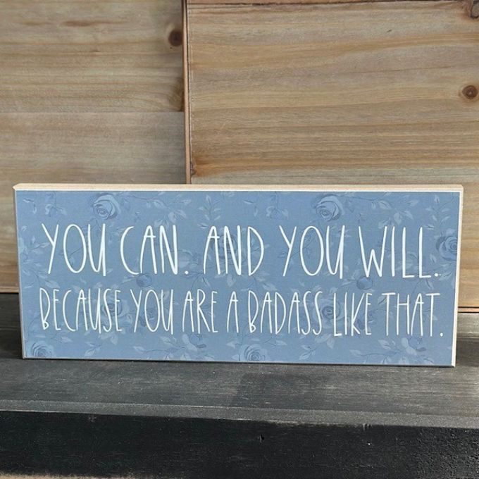 Motivational sign with text on a wooden surface available at Quilted Cabin in Airdrie
